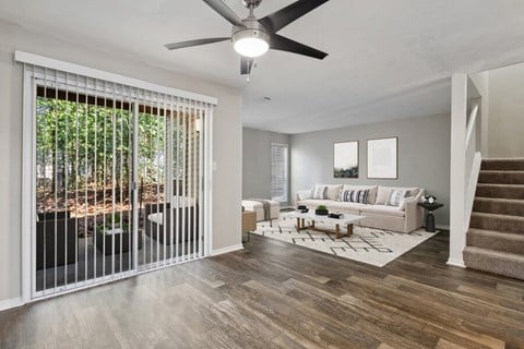 a living room with a couch and a ceiling fan